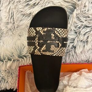 Tory Burch Black and Gold Snakeskin Slide Sandals.
